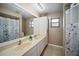 Well-lit bathroom with double sinks, a large mirror, and sleek fixtures at 4091 Lippman Rd, St Cloud, FL 34772