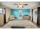 Spacious bedroom with a ceiling fan, wood floors and a blue accent wall at 4091 Lippman Rd, St Cloud, FL 34772