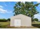 Exterior view of a storage shed boasts ample storage space, a neutral color scheme, and a well-maintained lawn at 4091 Lippman Rd, St Cloud, FL 34772