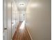 Bright hallway with wood-look flooring, leading to other rooms in the home at 4091 Lippman Rd, St Cloud, FL 34772