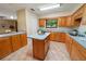 Bright kitchen with oak cabinets, island, modern appliances, and a seamless transition into the living area at 4091 Lippman Rd, St Cloud, FL 34772
