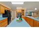 Spacious kitchen with wood cabinets, a central island, and modern appliances, perfect for culinary enthusiasts at 4091 Lippman Rd, St Cloud, FL 34772