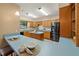 Well-lit kitchen featuring wood cabinets, a center island, modern appliances, and ample counter space at 4091 Lippman Rd, St Cloud, FL 34772