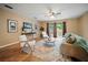Cozy living room with wood floors, modern furnishings, and sliding glass doors to the outdoor area at 4091 Lippman Rd, St Cloud, FL 34772