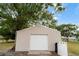 Metal outbuilding with a large garage door offers versatile space for storage or hobbies at 4091 Lippman Rd, St Cloud, FL 34772