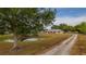 Home exterior view features pond and driveway, enhancing curb appeal with natural accents at 4091 Lippman Rd, St Cloud, FL 34772