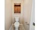 Clean, simple toilet room with wood accents and fixtures at 4091 Lippman Rd, St Cloud, FL 34772