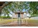 Elevated treehouse offers a unique outdoor retreat with a charming design and inviting blue ladder at 4091 Lippman Rd, St Cloud, FL 34772