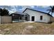 Backyard with a screen enclosed pool, a white privacy fence, and an open grass area at 414 Otter Creek Dr, Kissimmee, FL 34743