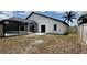 Backyard with a screen enclosed pool, a white privacy fence, and an open grass area at 414 Otter Creek Dr, Kissimmee, FL 34743