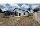 Backyard featuring a screen enclosed pool, white fence, and a view of the blue skies above at 414 Otter Creek Dr, Kissimmee, FL 34743