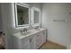 Updated bathroom featuring a dual sink vanity with framed light up mirrors and tile flooring at 414 Otter Creek Dr, Kissimmee, FL 34743