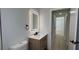 Well-lit modern bathroom featuring an illuminated mirror and updated vanity and hardware at 414 Otter Creek Dr, Kissimmee, FL 34743