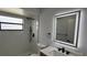 Modern bathroom featuring an illuminated mirror, updated vanity and black shower hardware at 414 Otter Creek Dr, Kissimmee, FL 34743