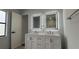 Bathroom featuring dual sink vanity with white cabinetry, new fixtures, and lighted mirrors at 414 Otter Creek Dr, Kissimmee, FL 34743