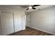 Bedroom with ceiling fan, hardwood floors and a closet at 414 Otter Creek Dr, Kissimmee, FL 34743