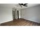 Bedroom featuring neutral paint, ceiling fan, closet and door leading to another room at 414 Otter Creek Dr, Kissimmee, FL 34743