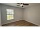 Bedroom with ceiling fan, hardwood floors, and modern feel at 414 Otter Creek Dr, Kissimmee, FL 34743