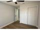 Comfortable bedroom with ceiling fan, hardwood floors and a closet for storage at 414 Otter Creek Dr, Kissimmee, FL 34743