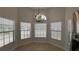 Eat in kitchen has tile flooring, three large windows, and a modern chandelier at 414 Otter Creek Dr, Kissimmee, FL 34743