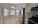 Bright breakfast nook features tile flooring, stainless refrigerator and a modern chandelier at 414 Otter Creek Dr, Kissimmee, FL 34743