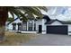 Charming home featuring a clean white exterior and dark accents, along with an attached two-car garage at 414 Otter Creek Dr, Kissimmee, FL 34743