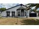 Charming single-Gathering home featuring a clean white exterior and dark accents, along with an attached two-car garage at 414 Otter Creek Dr, Kissimmee, FL 34743