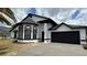Charming home featuring a clean white exterior and dark accents, along with an attached two-car garage at 414 Otter Creek Dr, Kissimmee, FL 34743