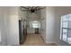 Spacious kitchen featuring stainless appliances, white cabinetry, and seamless access to the pool at 414 Otter Creek Dr, Kissimmee, FL 34743