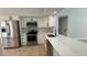 Bright kitchen featuring stainless steel appliances, white cabinets, and quartz countertops at 414 Otter Creek Dr, Kissimmee, FL 34743