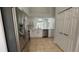 Modern kitchen boasts stainless steel appliances, white cabinets, and a view of the pool area at 414 Otter Creek Dr, Kissimmee, FL 34743