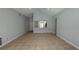 Open-concept living room featuring tile floors, light gray walls, and an opening to the kitchen area at 414 Otter Creek Dr, Kissimmee, FL 34743