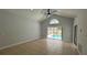 Bright living room with access to backyard pool, featuring tile flooring, gray walls, and ceiling fan at 414 Otter Creek Dr, Kissimmee, FL 34743