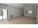 Bright living room with tile flooring and neutral paint, leading to outdoor patio and open kitchen at 414 Otter Creek Dr, Kissimmee, FL 34743