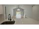 Open living room boasts high ceilings, view of the pool, and access to a modern kitchen at 414 Otter Creek Dr, Kissimmee, FL 34743