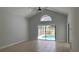 Bright living room featuring tile flooring, light gray walls, and ceiling fan with view of pool at 414 Otter Creek Dr, Kissimmee, FL 34743