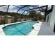 Backyard screened-in pool area featuring a clean pool with clear water and lots of space for lounge chairs at 414 Otter Creek Dr, Kissimmee, FL 34743