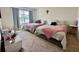Shared bedroom with two twin beds, neutral carpet, and large window at 4373 Deleon St, Haines City, FL 33844