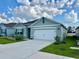Beautiful single-story home featuring a manicured lawn and a convenient two-car garage at 4373 Deleon St, Haines City, FL 33844