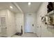 Hallway with multiple doors, decor shelves and tiled floor at 4373 Deleon St, Haines City, FL 33844