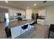 Spacious kitchen with a large granite island, stainless steel appliances, and white cabinets at 4373 Deleon St, Haines City, FL 33844