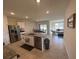 Open kitchen featuring an island with sink and modern appliances at 4373 Deleon St, Haines City, FL 33844