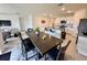 Open concept living space with tile floors and modern décor with view into kitchen at 4373 Deleon St, Haines City, FL 33844