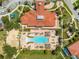 An aerial view shows the neighborhood pool and clubhouse at 438 Marcello Blvd, Kissimmee, FL 34746