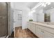 Bright bathroom featuring double sinks, quartz countertops, and wood-style flooring at 438 Marcello Blvd, Kissimmee, FL 34746