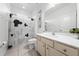 Bright bathroom featuring a modern vanity, tiled floors, and a shower with a playful Mickey Mouse themed curtain at 438 Marcello Blvd, Kissimmee, FL 34746