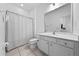 Well-lit bathroom features a shower-tub combination and ample cabinet storage space at 438 Marcello Blvd, Kissimmee, FL 34746