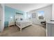 Cozy bedroom with large windows providing natural light, a queen-size bed, and blue accent wall at 438 Marcello Blvd, Kissimmee, FL 34746