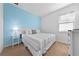 Cozy bedroom featuring a bright blue accent wall, one window, carpet and neutral walls at 438 Marcello Blvd, Kissimmee, FL 34746