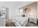 Comfortable bedroom featuring a queen bed, neutral color scheme, and tasteful wall decor at 438 Marcello Blvd, Kissimmee, FL 34746